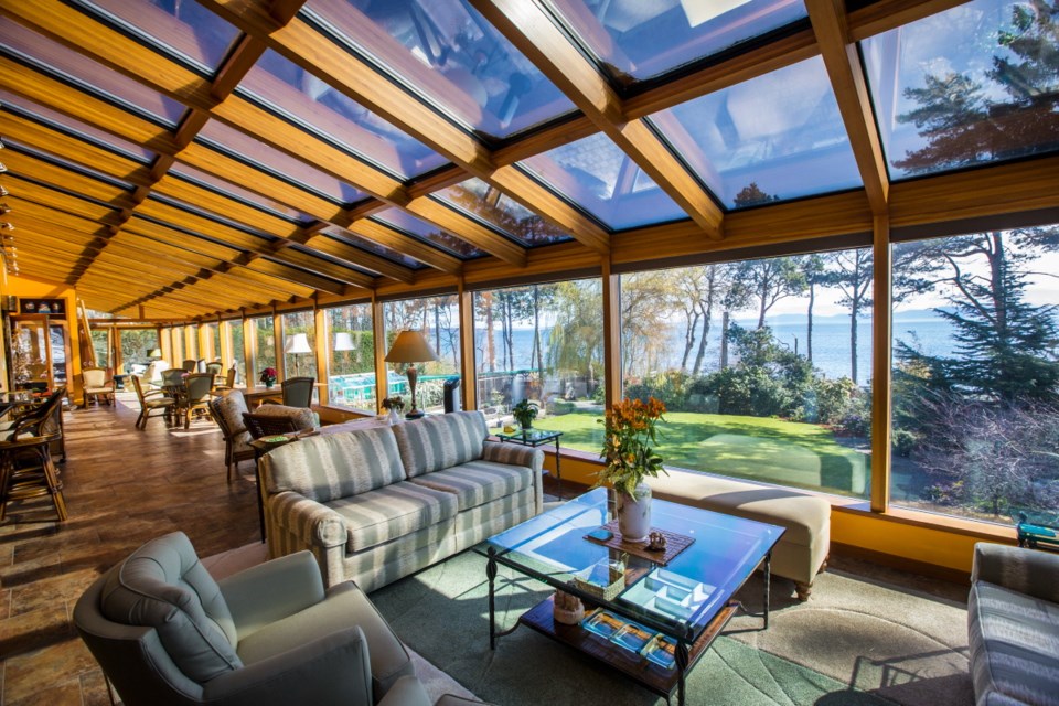 A long glass wall and row upon row of glass panes above make the great room of this 5,000-square-foot Cordova Bay home look as if it has been painted with sunshine. The one-acre garden is featured in the Conservatory of Music Mother's Day Musical Garden Tour.