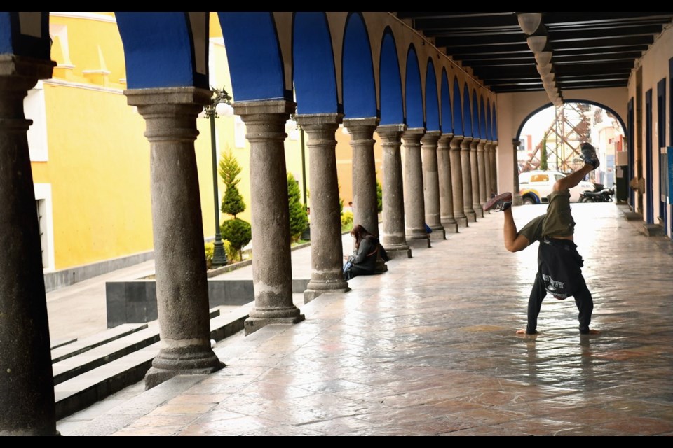 A man break dances in the streets of Puebla, Mexico.