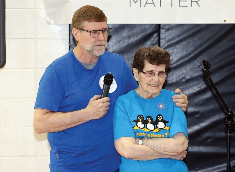 Honouree Victoria Taylor, right, and her son Robert Taylor, left, watch a short slideshow together as part of the 2018 Investors' Group Walk for Alzheimer's on Sunday afternoon at the YMCA of Northern BC.