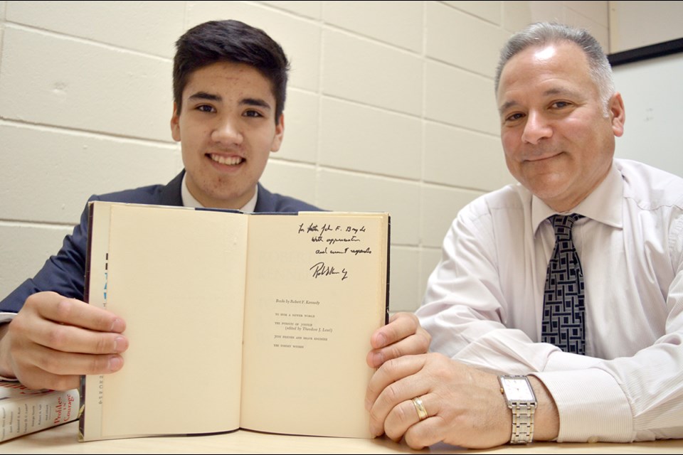 Erik Wendland, to the left, and Howe Sound principal Nick Pascuzzi show off what appears to be an autograph from Robert F. Kennedy.