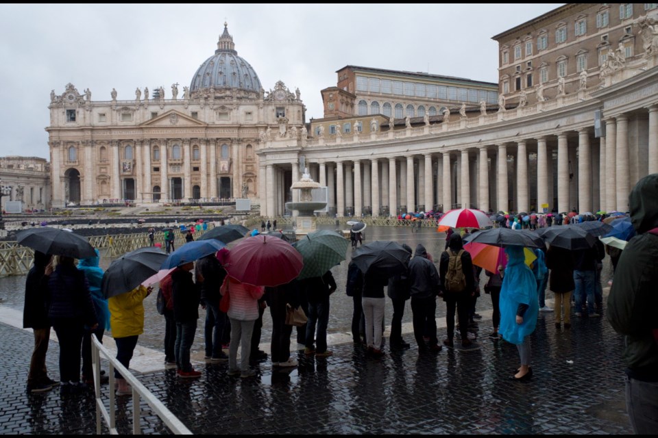 In this photo taken on April 9, 2018 people wait in line to get into the Vatican museum in Vatican City, Italy. One can hardly see the treasures of Rome's top attractions these days without bumping arms with the hordes of tourists. (AP Photo/Virginia Mayo)