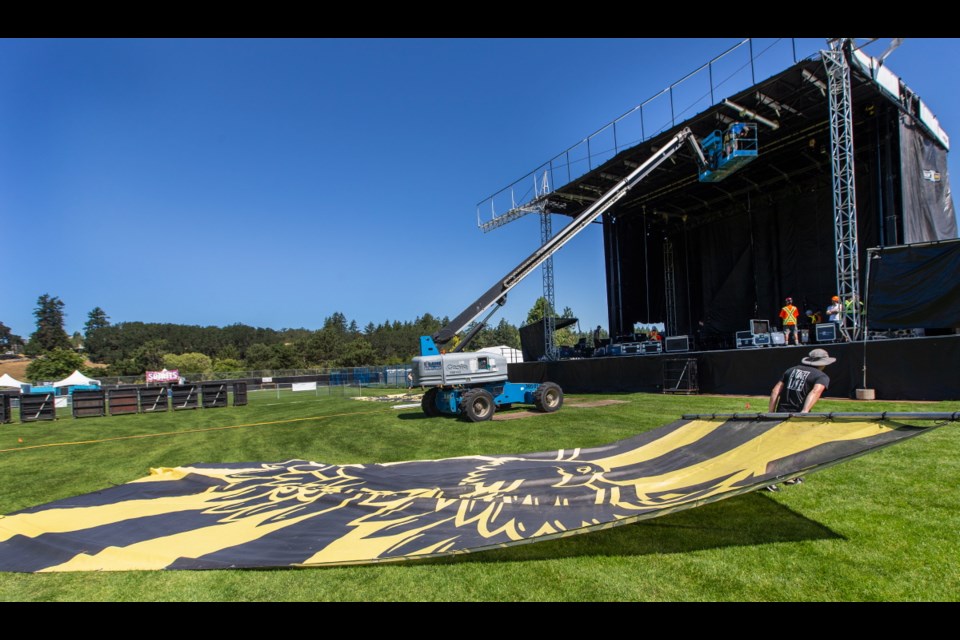 Workers install the main stage for the Rock the Shores music festival at Juan de Fuca Recreation Centre on Thursday. The three-day festival kicks off Friday night.  [July 12, 2018]