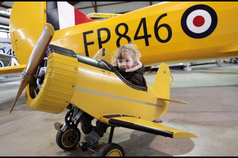 A young aviation fan checks out an appropriately sized plan during a previous open house at the saʴý Aviation Museum. This year's open house runs 10 a.m. to 4 p.m. Saturday at 1910 Norseman Rd. in North Saanich.