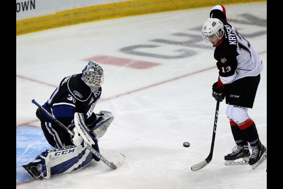 Royals goaltender Griffen Outhouse stares down Cougars forward Max Kryski during the first period of the season opener at Save-On-Foods Memorial Centre on Friday night.