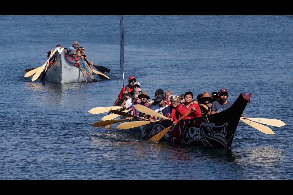 Two canoes arrive at the Inner Harbour concourse after they were paddled from the Songhees on Friday, as part of the canoe crossing protocol welcome. The arrival of the canoes marked the start of the Victoria Indigenous Cultural Festival, on the grounds of the Royal B.C. Museum this weekend. June 21, 2019
