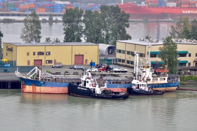 Tugboats prepare to haul the MV Sea Sun from its longtime berth near Queensborough to Nanaimo where it will be dismantled and recycled.