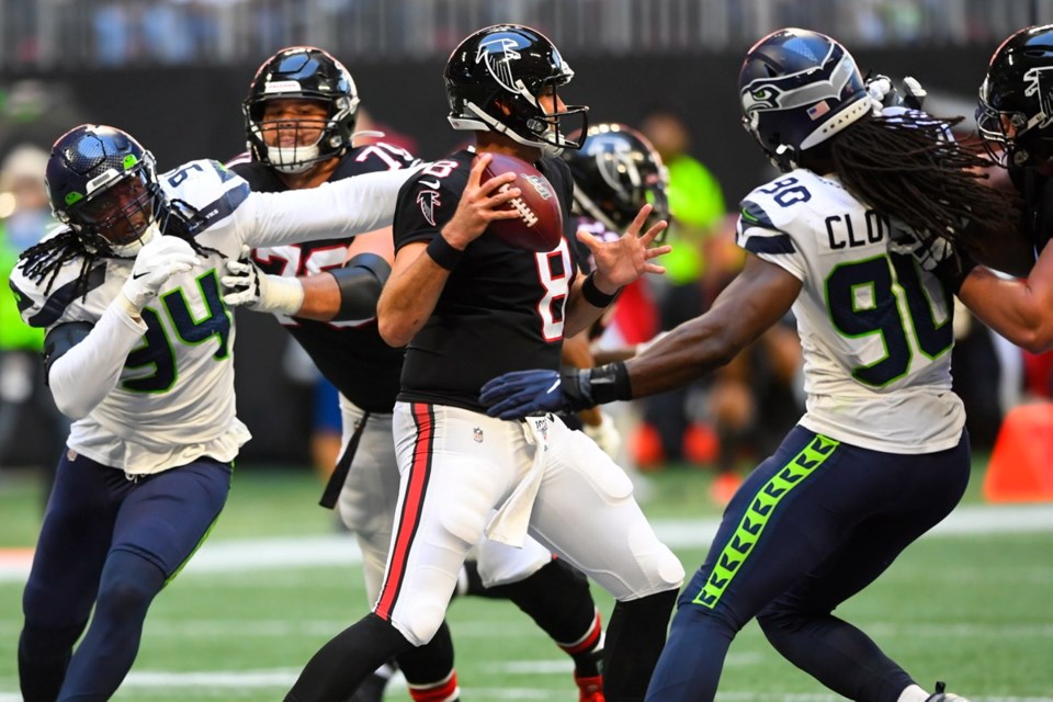 Atlanta Falcons quarterback Matt Schaub (8) works under pressure from the Seattle Seahawks in the pocket during the second half of Sunday's game in Atlanta. The Seattle Seahawks won 27-20.