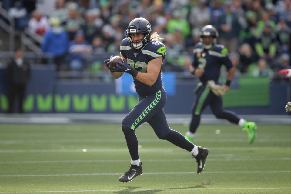 Seattle Seahawks quarterback Russell Wilson (3) greets tight end Jacob  Hollister, center, after Wilson passed to Hollister for touchdown against  the Tampa Bay Buccaneers during the first half of an NFL football