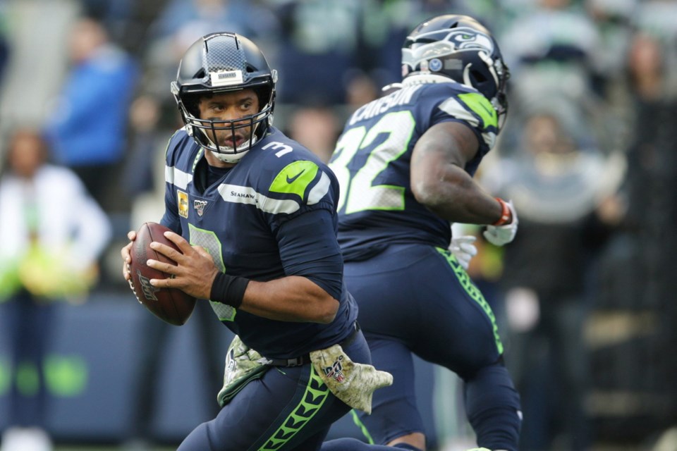 Seattle Seahawks quarterback Russell Wilson (3) greets tight end Jacob  Hollister, center, after Wilson passed to Hollister for touchdown against  the Tampa Bay Buccaneers during the first half of an NFL football