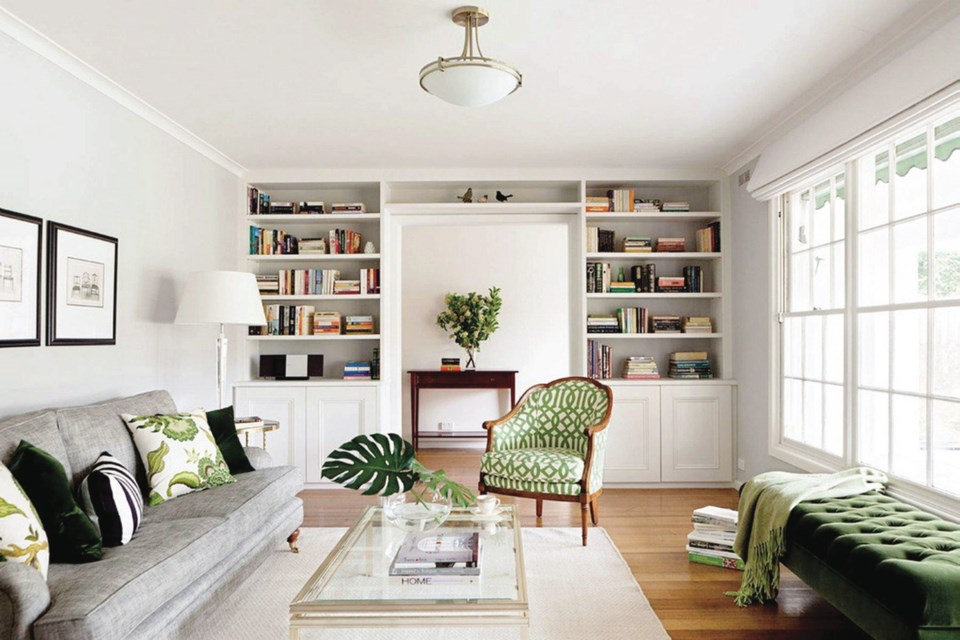 Without the infusion of leafy greens in a chair, pillows and bench, this all-white room might feel sterile.