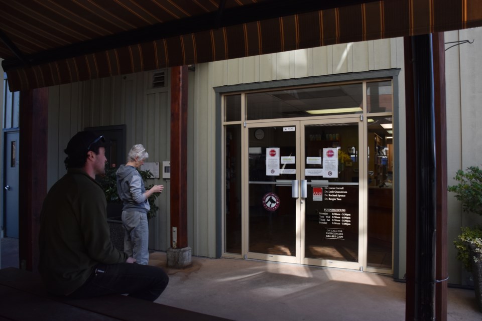 A man waits for an order outside a veterinary clinic in Sechelt on March 18.