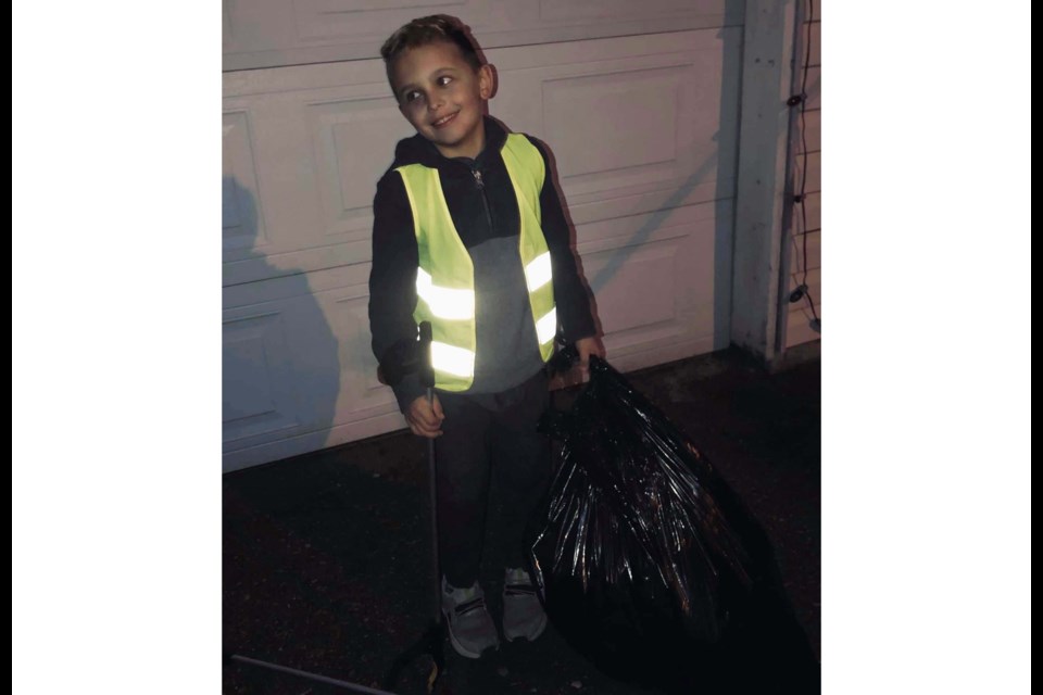 Kate-Marie Harvey's son, Luka, 8, didn't take long to load up his first bag of garbage Thursday evening. Facebook photo