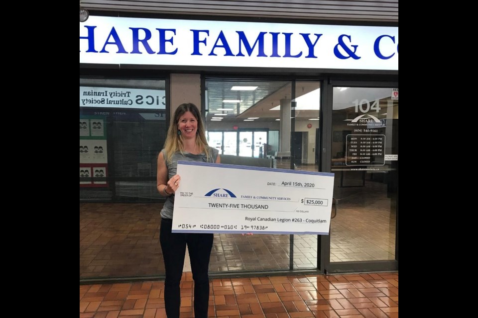 SHARE CEO Claire MacLean shows off a $25,000 cheque donated to the Tri-Cities food bank from the Coquitlam branch of the Royal Canadian Legion