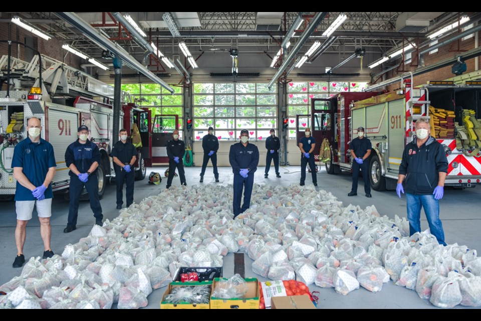 Burnaby firefighters at the Metrotown fire hall prepare to deliver food hampers donated by the Burnaby Firefighters Charitable Society.