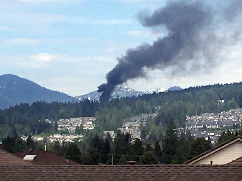 Smoke pours from a burning house in the 1500 block of Coast Meridian Road