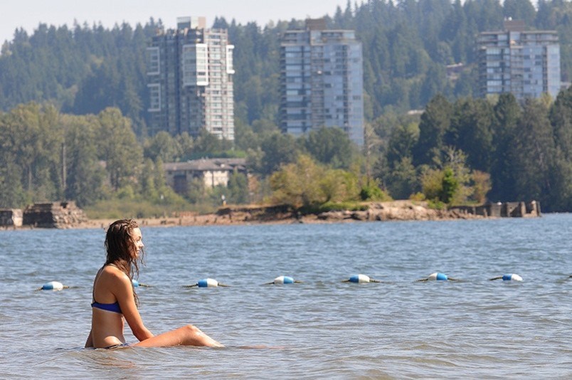 A woman cools off in the water at Old Orchard Park beach in Port Moody, a popular spot to visit in the warm weather.