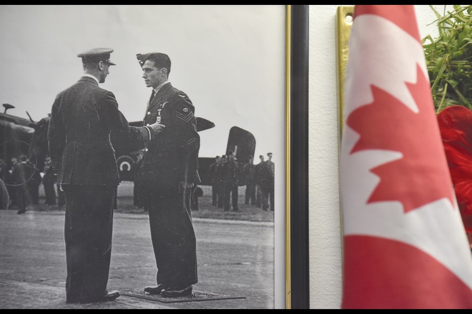 Royal Canadian Air Force Pilot Officer Marcel Croteau receives a Distinguished Flying Medal from King George VI in Linton-on-Ouse 1944 in North Yorkshire.