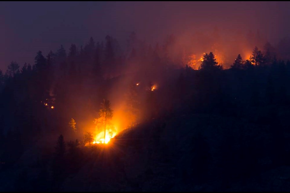Flareups are seen from the Christie Mountain wildfire along Skaha Lake in Penticton, B.C. Thursday, August 20, 2020. An evacuation order for a fire in the southern Interior of British Columbia has been rescinded while other areas are still seeing raging blazes.THE CANADIAN PRESS/Jonathan Hayward