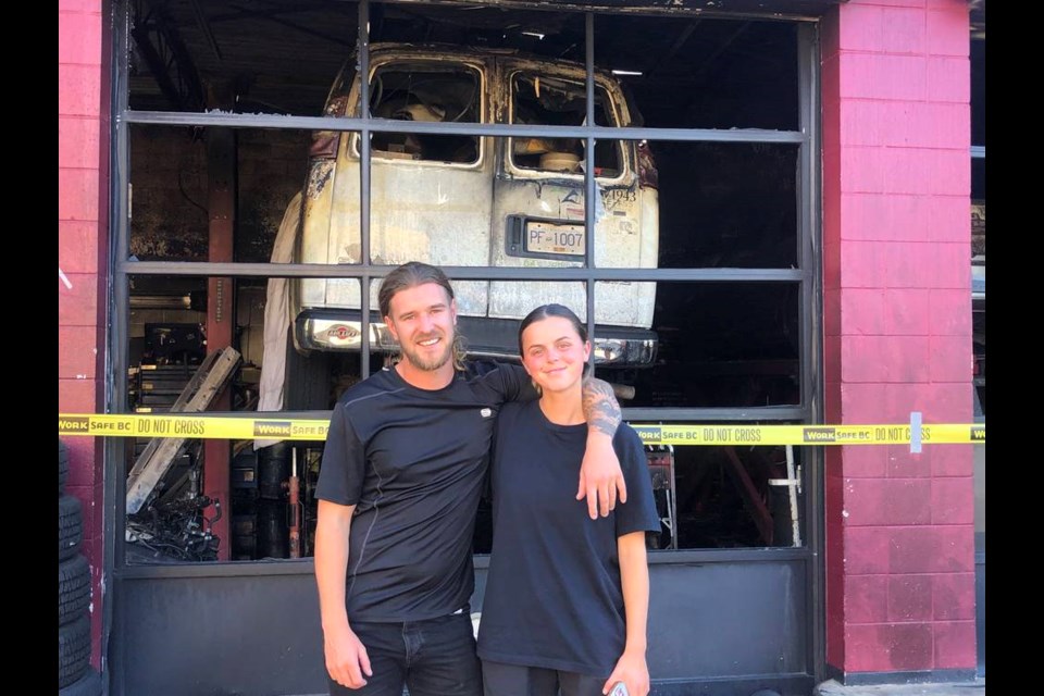 Robert Pearce and Jess Choules with their burnt-out van at Big O Tires location in View Royal