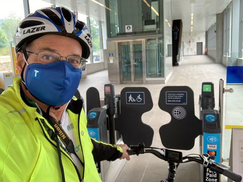 Coquitlam mayor Richard Stewart takes his bike through a SkyTrain toll gate in Coquitlam. In the lat