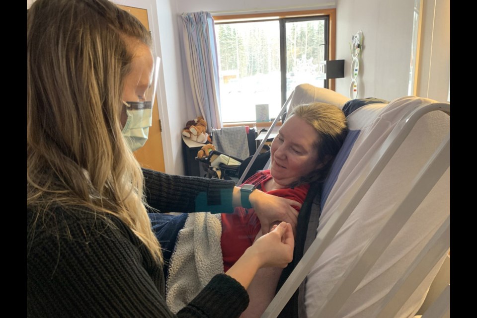 Heather Kirk was the first long-term care resident at Mackenzie and District Hospital to receive her COVID-19 immunization Thursday. The immunization was administered by Stephanie Clarke, primary care nurse.