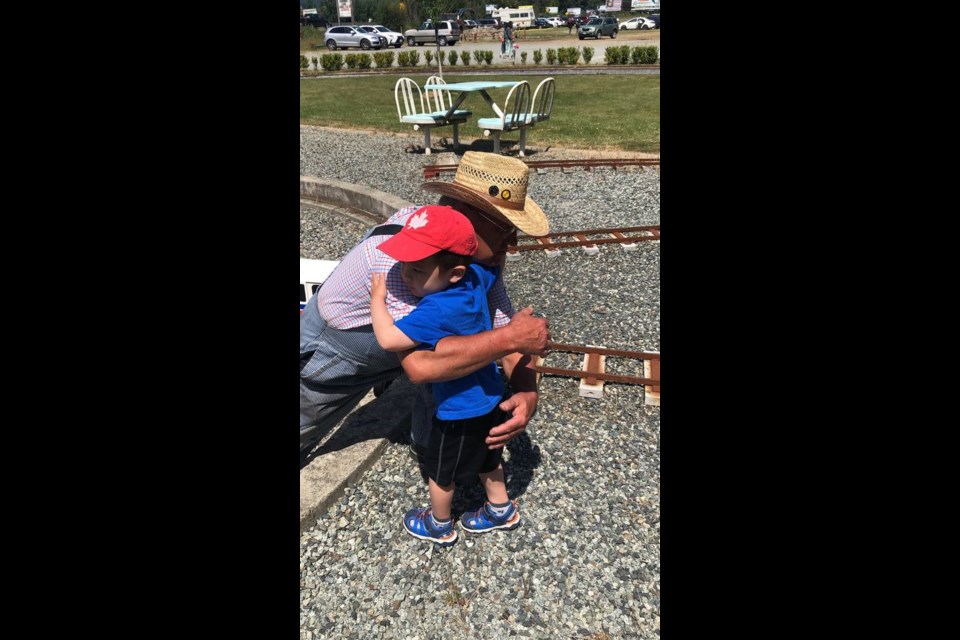 Jacob Baggott hugs his favourite engineer, Claude Jolivet, at Heritage Acres. COURTESY ALI BAGGOTT