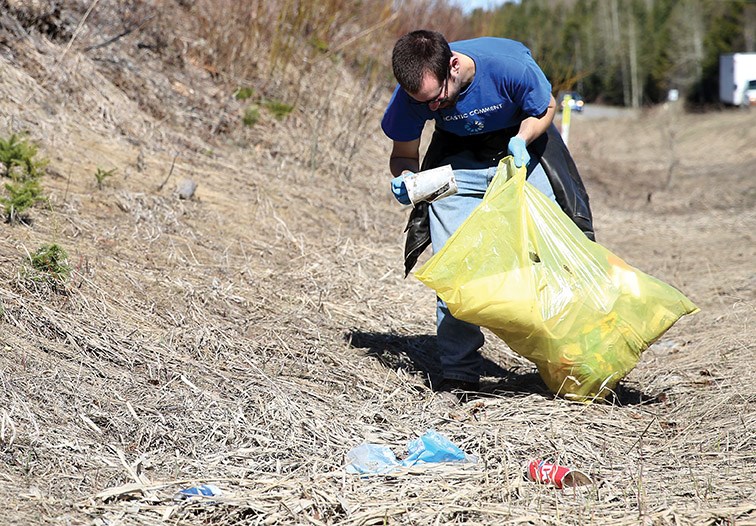 Peter Griffiths picks up litter and garbage from a ditch on Foothills Boulevard near the dump during the Annual Spring Clean Up in 2019,