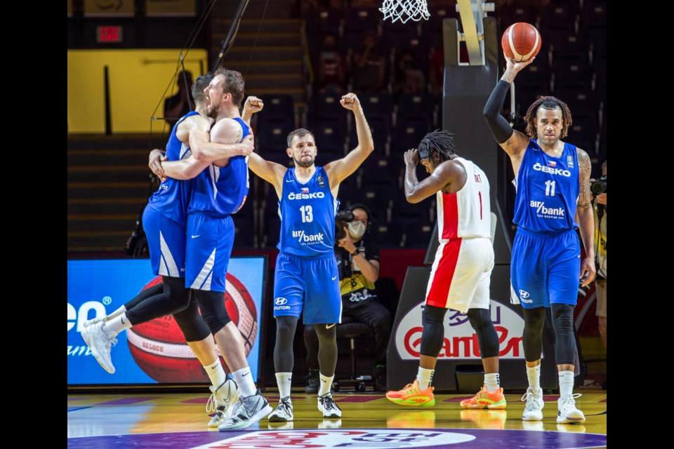 saʴý's Luguentz Dort crosses the court as the Czech team celebrates its semifinal victory at the FIBA Olympic Qualifying Tournament at the Save-on-Foods Memorial Centre in Victoria on Saturday, July 3, 2021. The Czech Republic sank a basket with just 1.8 seconds left on the clock to defeat saʴý 103-101 in overtime. DARREN STONE, TIMES COLONIST