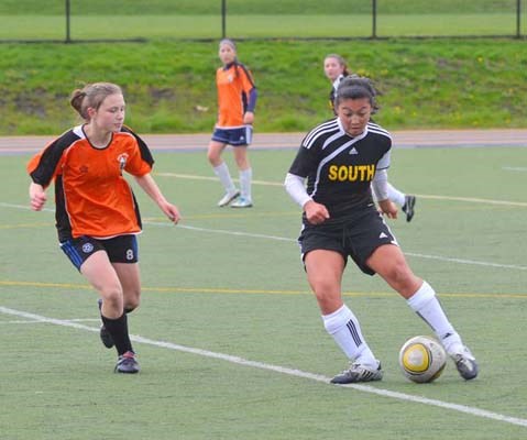 Jumping for joy: The Burnaby South Rebels, in black, defeated New Westminster 4-1 in district high school girls' semifinal soccer at Mercer Stadium on Tuesday. Seina Kashima, Danijela Gordic, Jasmine Manhas and Stephanie Labbe scored for the Rebels.