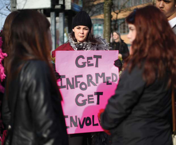 Showing support: Ashley Pitt, a waitress at the Paramount, shows support for the Paramount at a rally in uptown New Westminster on Saturday.