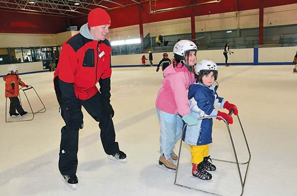 Around we go: Ben Davies checks on Paige and Sarah Mercier, who were among the kids who enjoyed skating at Moody Park Arena on Wednesday afternoon.