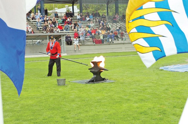 Ready ... Bert Houston touches off the anvil for the start of the 21-anvil salute.