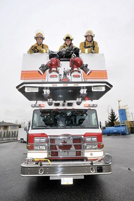 New toy: New Westminster Fire and Rescue Services welcomes its newest vehicle to the fleet. After staff is trained in driving and operating the new aerial platform truck, it hits the streets. Joe Laing, Don Edwards and Ray McCullough get a good view from the top of the new truck.