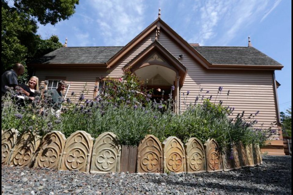 A flowerbed is edged in garden tiles, which were copied from broken tiles found buried on the property.