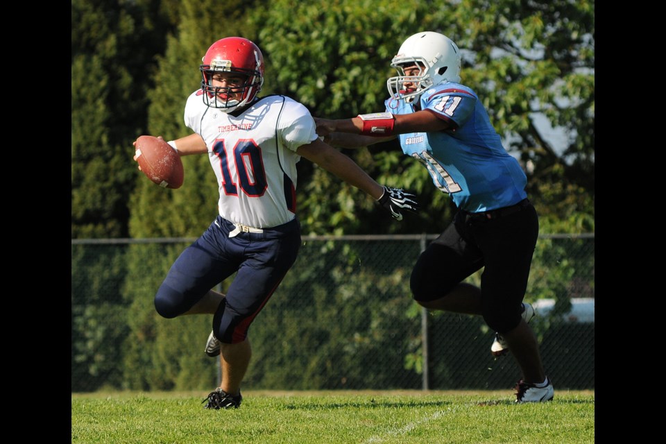 Griffins quarterback James Hanoomansingh (No. 11) switches to safety on defence and chases down the Timberline Wolves quarterback for a sack Sept. 13 at Eric Hamber. The Griffins lost 14-0 to the visitors from Campbell River.