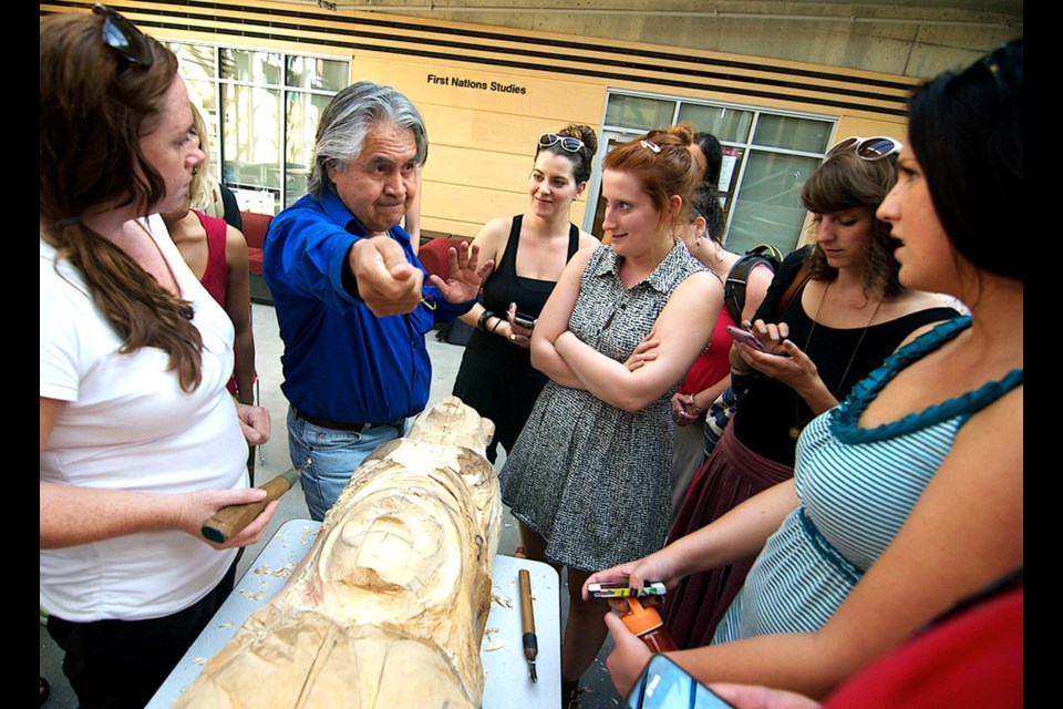 Cutlines: First Nations carver Isadore Charters brought a totem pole to SFU's Burnaby campus to share his experience of growing up in a residential school.