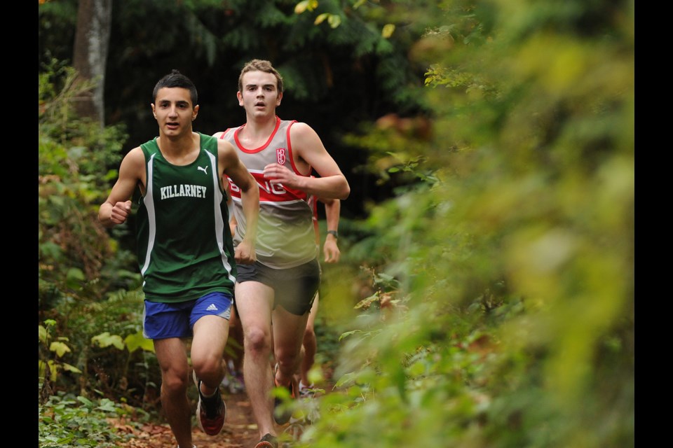 Killarney's Aran Rafie-Pour (left) and Max Trummer of Lord Byng go toe to toe in the third of five high school cross-country meets Oct. 9 at Fraserview. Trummer won this outing, and Rafie-Pour finished a close second.