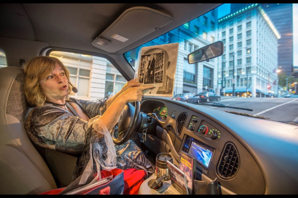 Jake Jacobson shows a photograph from the Arctic Club (through window right) where an infamous suicide took place.