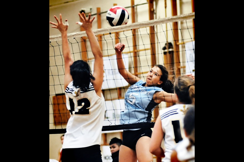 Saya Engleson (No. 5) knocks the ball over the net for Point Grey in a senior girls city semi-final Oct. 29 against Prince of Wales.