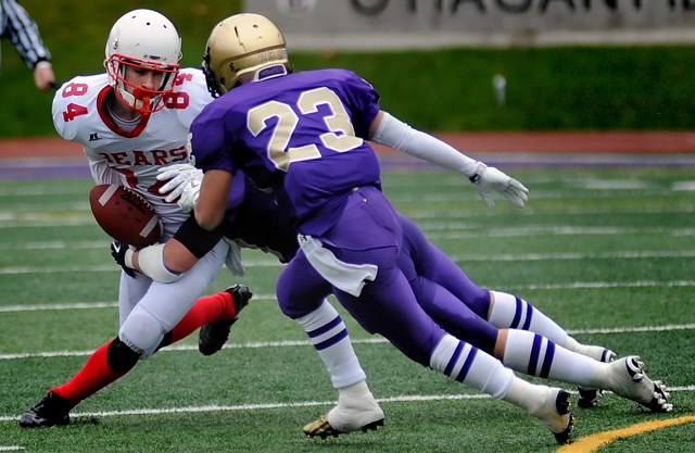 The 鶹ýӳCollege Fighting Irish double-team a Mt. Boucherie Bear in a AAA varsity playoff game Nov. 9 at O’Hagan Field. The Fighting Irish posted a 34-21 victory.