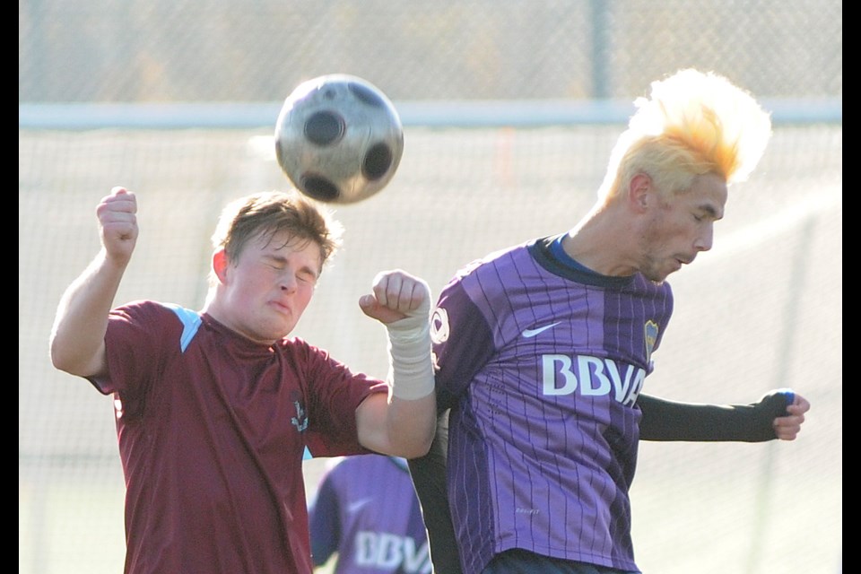 Hamber's Emis Weinstein-Wright, in maroon, fights for position in the air against a player from Surrey’s Elgin Park Nov. 23 at Burnaby Lake Parks. Hamber won 1-0.