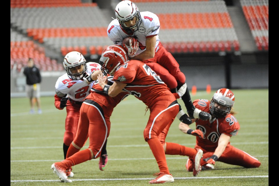 Carson Graham's Lucas Bill flies into the end zone for a fourth quarter touchdown against John Barsby in the provincial AA final played Saturday at BC Place. The Eagles came back to earth when the clock ran out on their frantic last-minute drive and Barsby claimed a 21-20 win.