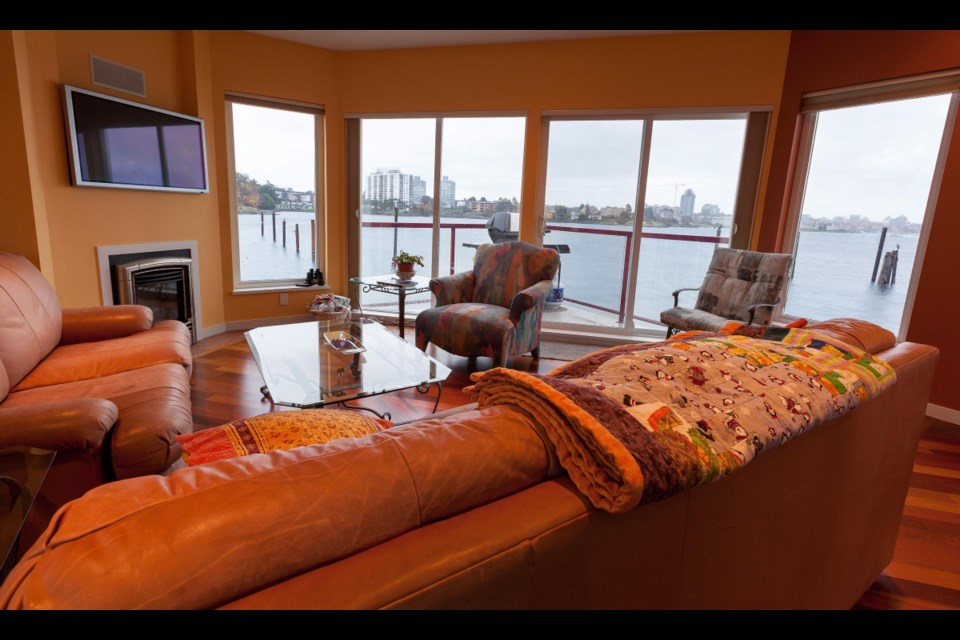 The living room sofas are oriented to the ever changing water scape at Esquimalt Mayor Barb Desjardins' float home in Esquimalt.