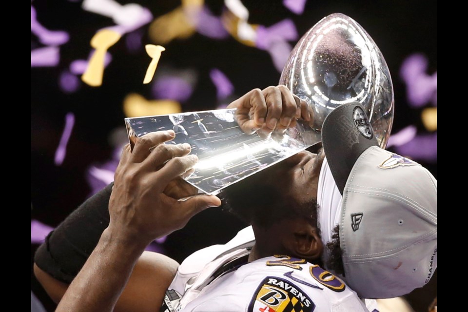 Baltimore Ravens safety Ed Reed lifts the Lombardi trophy with