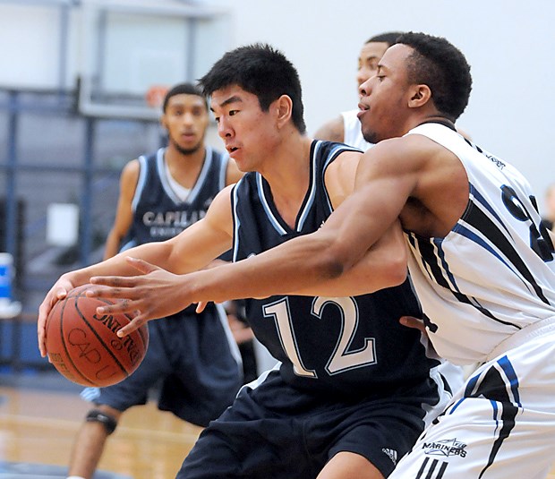 Capilano's Sai Zhang backs down a VIU defender during a 67-62 win for the Blues Saturday at the Sportsplex.