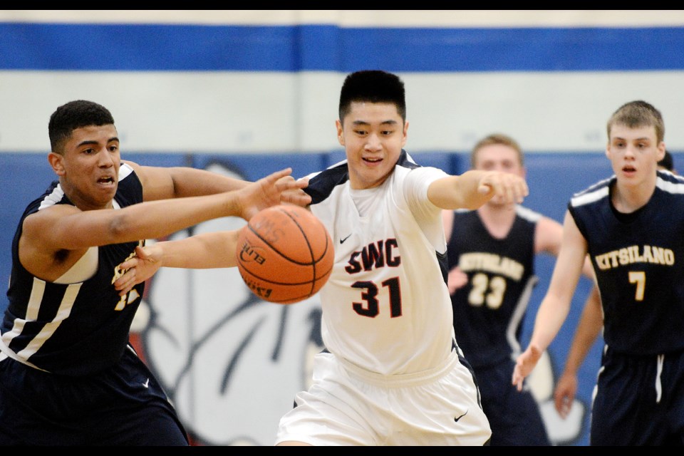 Grade 10 forward Harry Liu [No 31] recorded 14 first-quarter points and kept the Winston Churchill Bulldogs alive after a rocky start against the team from Kitsilano secondary. photo Jennifer Gauthier