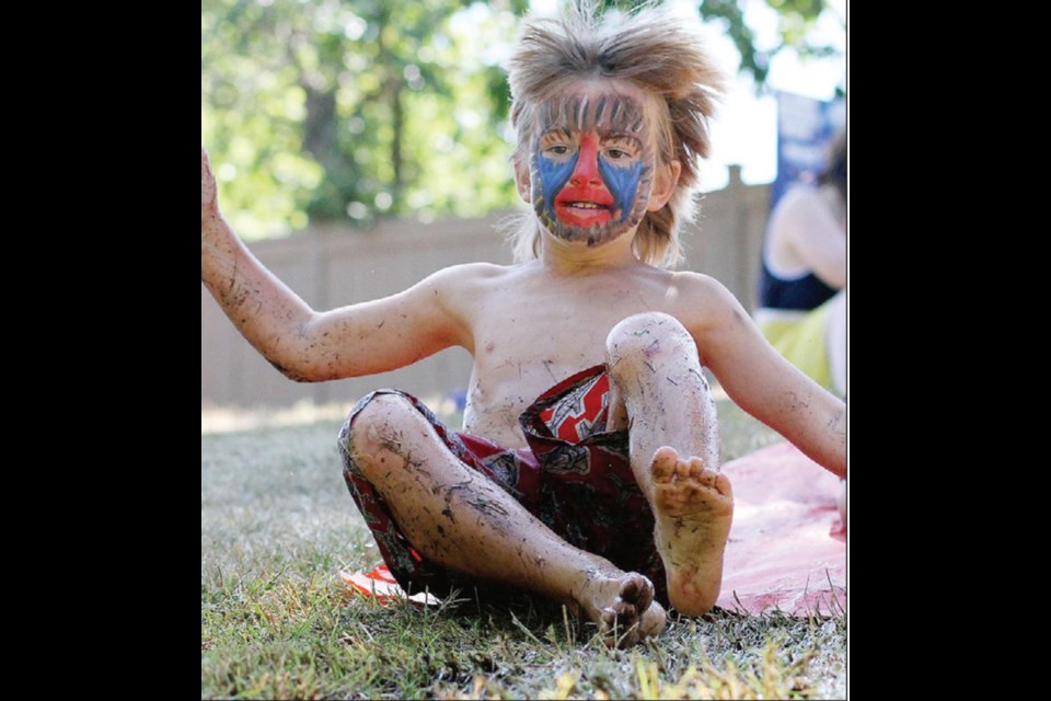 Luke Neary, 6, gleefully tests the Slip 'n' Slide toy during Sunday's Gorge Swim Fest.