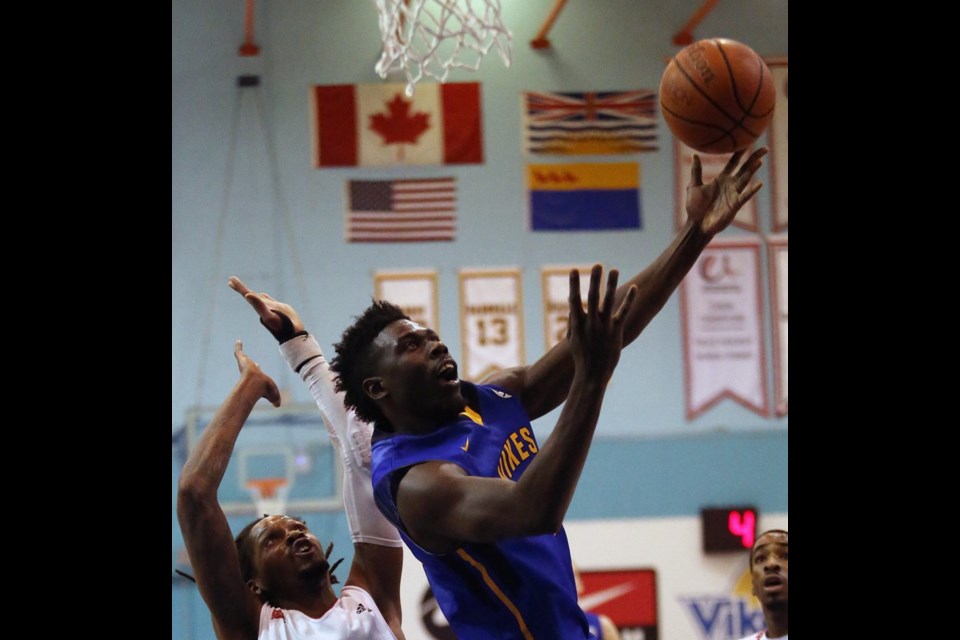 UVic&Otilde;s Terrell Evans, right, goes for a layup against Winnipeg&Otilde;s Steven Wesley during Game 2 of Canada West men&Otilde;s basketball playoff action at McKinnon Gym on Saturday.