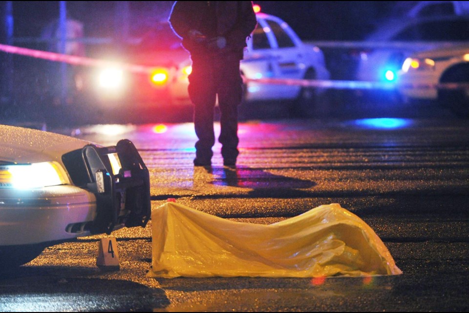 Inquest: A tarp covers evidence after a police related shooting in Burnaby on Jan. 31, 2013. The results of the shooting will be the subject of a coroner's inquest in July.