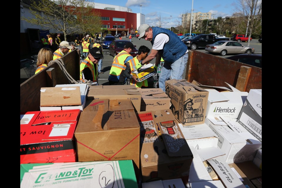 This file photograph shows volunteers helping to unload boxes of books donated to the Times Colonist Book Drive in 2014. This year's book drive kicks off on Saturday, April 27, and Sunday, April 28, with the collection weekend, your chance to donate used books. The sale itself will be at the Victoria Curling Club on Quadra Street on May 11 and 12. The sale supports literacy programs on Vancouver Island.